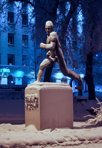 Statue against clear sky at night