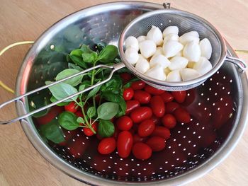 High angle view of chopped fruits in bowl on table