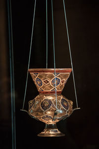 Close-up of decoration hanging against black background