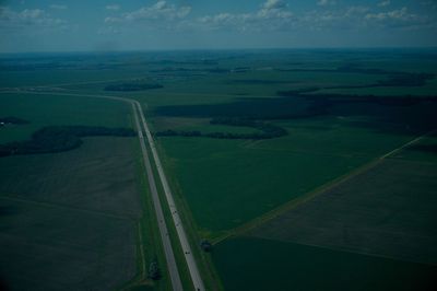 Aerial view of green landscape against sky