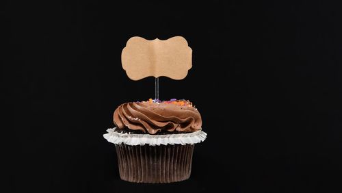 Close-up of cupcakes against black background