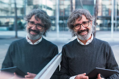 Portrait of young man using digital tablet