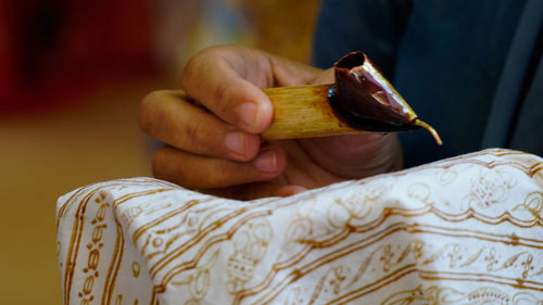 Close-up of woman holding cross