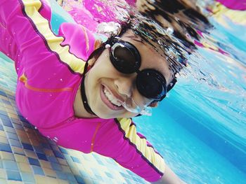 Portrait of a smiling girl swimming in pool