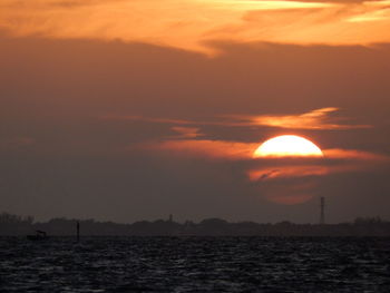 Scenic view of sea against orange sky