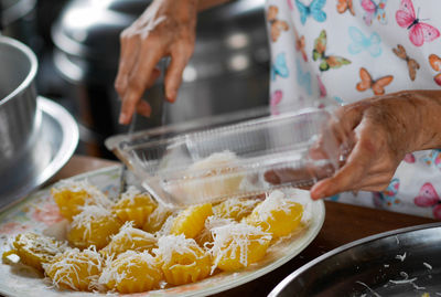 Midsection of woman preparing food in kitchen