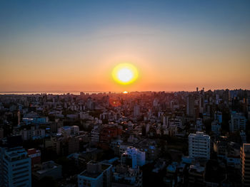 Cityscape against sky during sunset