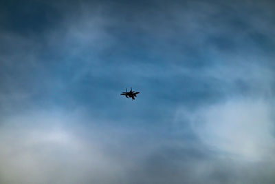 Low angle view of airplane flying in sky