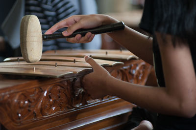 Cropped image of hand playing gamelan