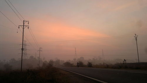 Country road against cloudy sky