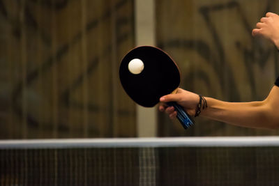 Close-up of hand playing table tennis