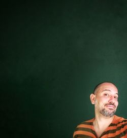 Portrait of man against green background