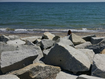 High angle view of rocks on beach against sky