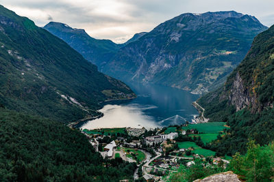 High angle view of lake and mountains against sky