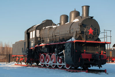 Train in snow against clear sky