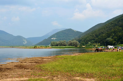 Scenic view of lake against cloudy sky