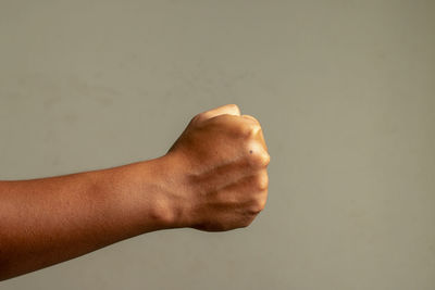 Close-up of hand against gray background