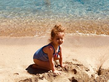 High angle view of girl sitting on beach