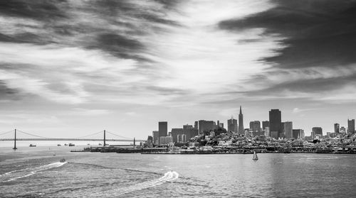 Cityscape against cloudy sky