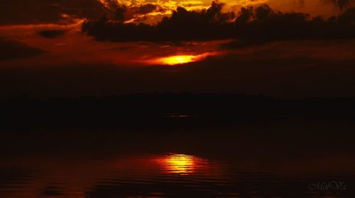 Scenic view of lake against romantic sky at sunset