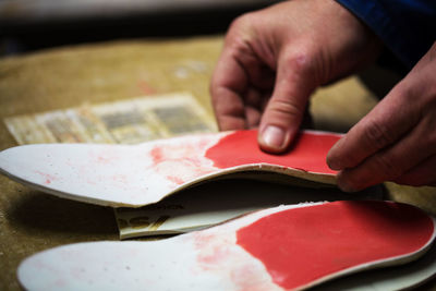 Midsection of man making footwear