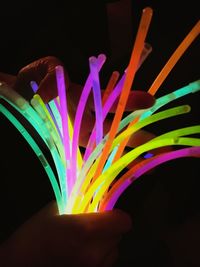 Close-up of colorful illuminated lights over black background