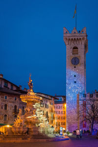 Statue of illuminated building at night