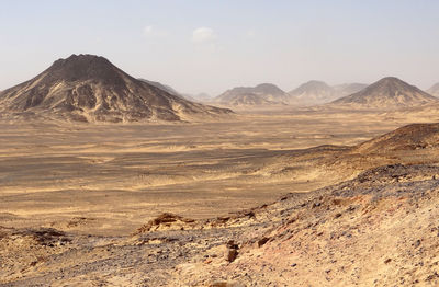 Scenic view of arid landscape against sky