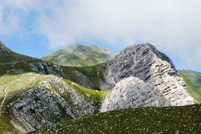 Low angle view of rocks against sky in montemonaco, marche 