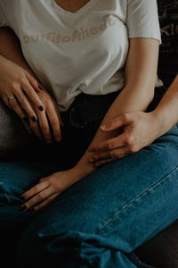 Midsection of woman sitting at home