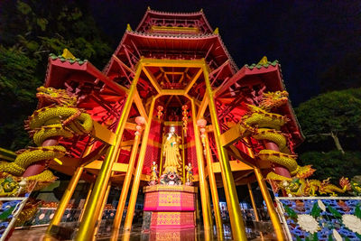 Low angle view of illuminated temple building at night
