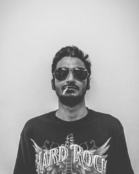 Portrait of young man looking at white background