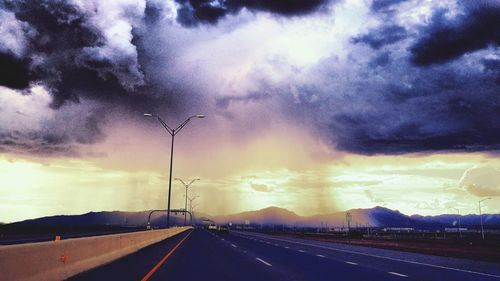 Road against dramatic sky during sunset