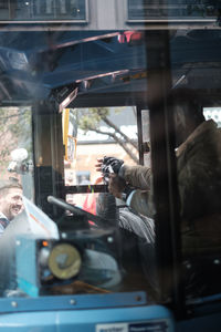 Reflection of man in car window