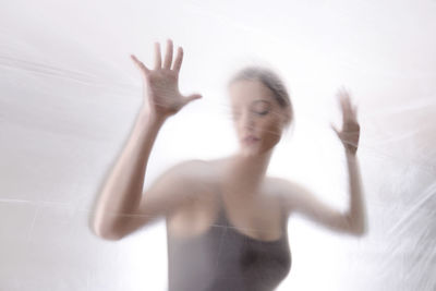 Close-up of woman with hands up