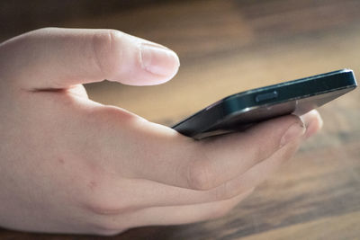 Close-up of hand holding smart phone