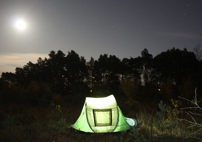 Tent on field against sky at night