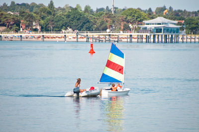 People enjoying in sailboat at sea