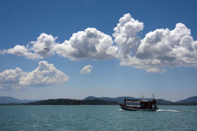 Sailboat sailing on sea against sky