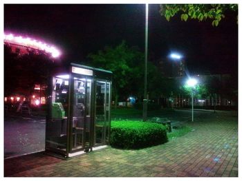 View of illuminated street lights at night