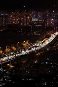 High angle view of illuminated city lit up at night