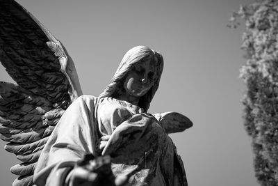 Low angle view of statue against sky