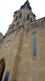 Low angle view of bell tower against sky