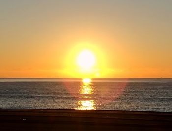 Scenic view of sea against orange sky