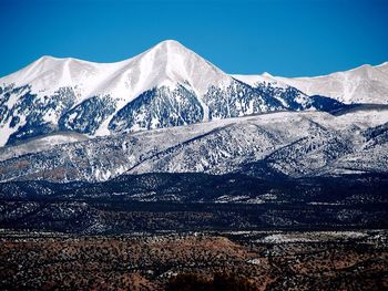 Scenic view of snowcapped mountains against clear sky