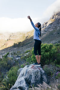 Rear view of man standing on mountain