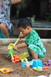 Portrait of boy playing with toys