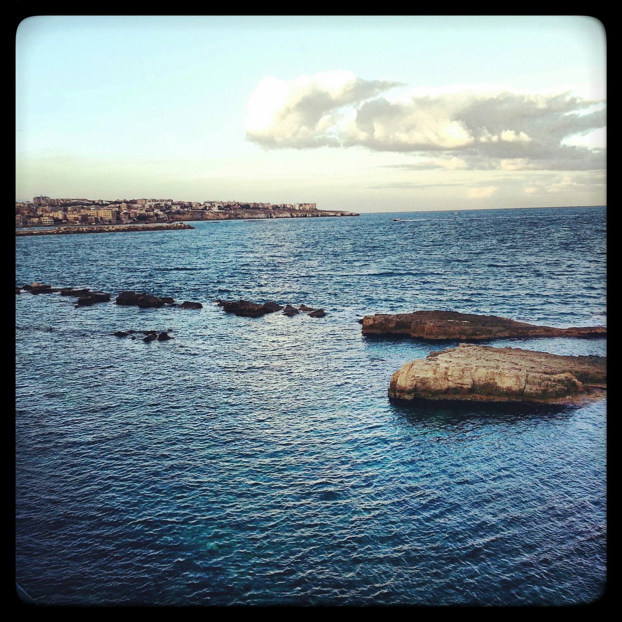 transfer print, sea, water, auto post production filter, sky, tranquil scene, horizon over water, tranquility, scenics, waterfront, beauty in nature, nature, rippled, rock - object, idyllic, cloud, rock, cloud - sky, ocean, outdoors