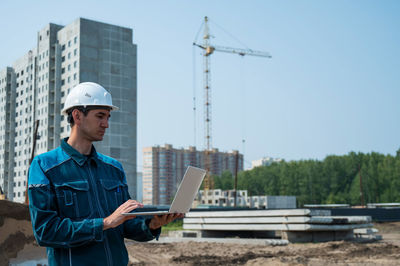 Side view of man working at construction site