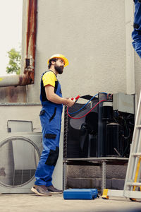 Side view of man working at construction site